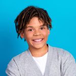 Smiling young man on blue background