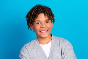 Smiling young man on blue background