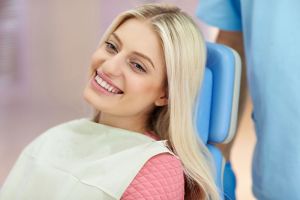 Smiling young woman seated at orthodontics appointment