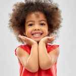 Smiling young girl in red shirt